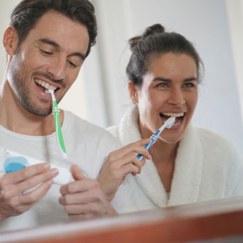 Couple brushing teeth together
