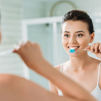 Beautiful smiling girl brushing teeth